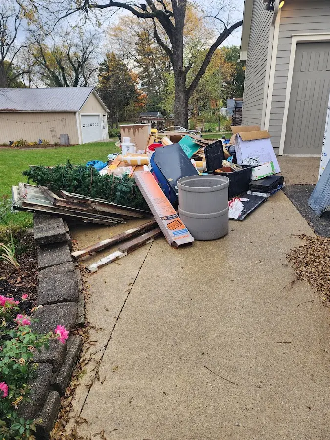 Dumpster being loaded with debris for Estate Cleanout Dumpster Rental in West Point